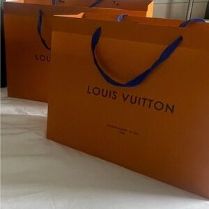 Two Bold Orange shopping Bags 🛍️ with Blue lettering and Handles